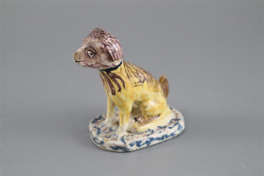 A Continental faience model of a seated dog, mid 18th century, possibly Brussels,